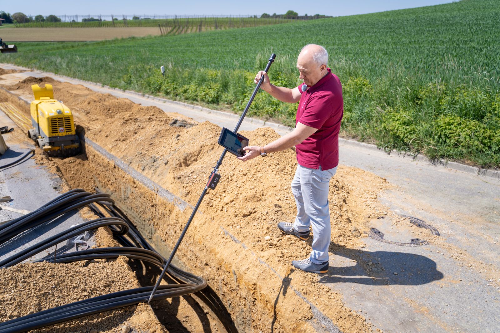 Technician operating ground penetrating radar equipment on a site